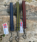 Huken dog safety handle attached to a short leash for secure control during walks, shown in the image.